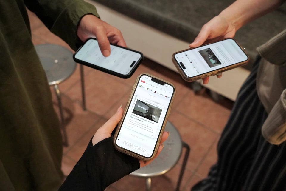Three hands hold three phones, each of which is displaying a different view of the Plot app.