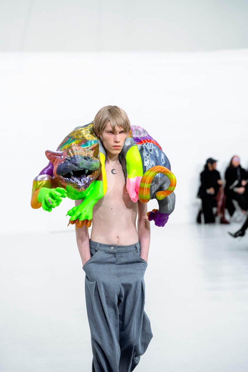 A person walking with a large, colorful wearable neck sculpture of a jungle cat