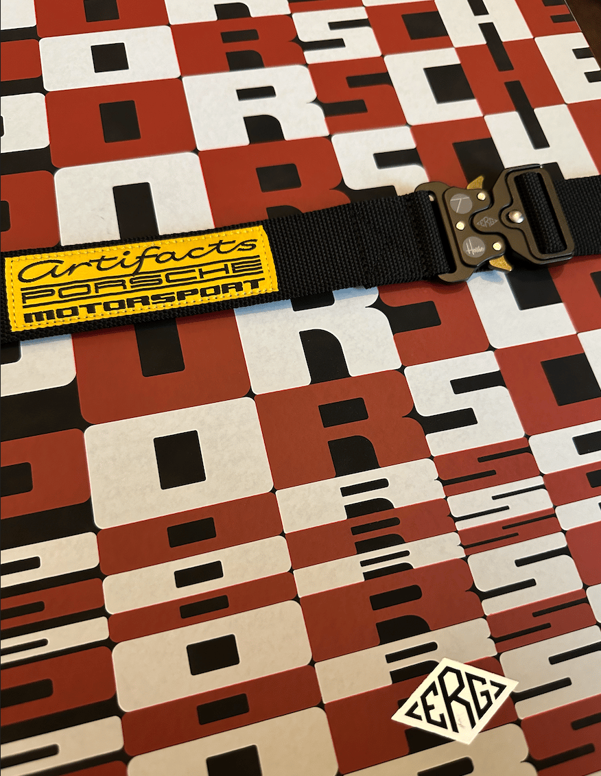 Pattern with letters and a seat-belt with fancy buckle. All part of the unboxing experience of this tome.