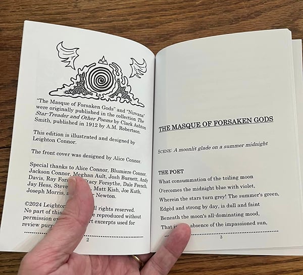 A hand holds open the book, showing pages 2 and 3. 2 gives copyright information, 3 is the beginning of the poem.