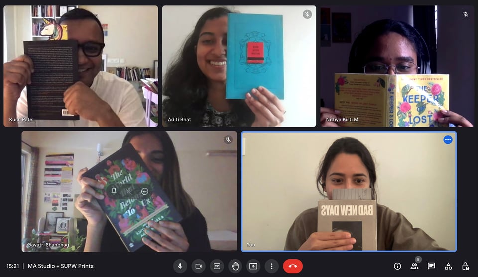 A screenshot of MA Studio + SUPW Workshop 2 held online and remotely on November 14, 2022. The image courtesy of Neeraja D, features five members of the workshop (from L to R anti-clockwise: Gayatri Shanbhag, Neeraja D, Nithya Kirti M., Aditi Bhat, and Kush Patel) holding a text or reference each as a playful nod to some of the opening questions and orientations to the Care Matters and Justice Dreams (MA) Studio + Super WomXn (SUPW) Print collaboration.
