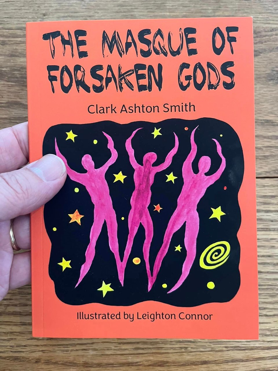 Cover of a small book that says The Masque of Forgotten Gods and shows three abstract figures against a starry background.