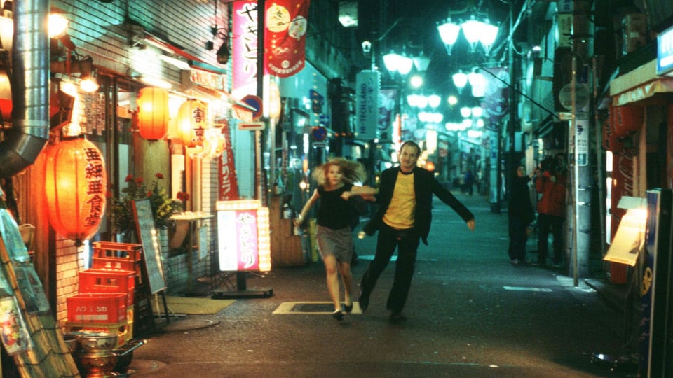 Charlotte (Scarlet Johansson) and Bob (Bill Murray) running through the side streets of Tokyo