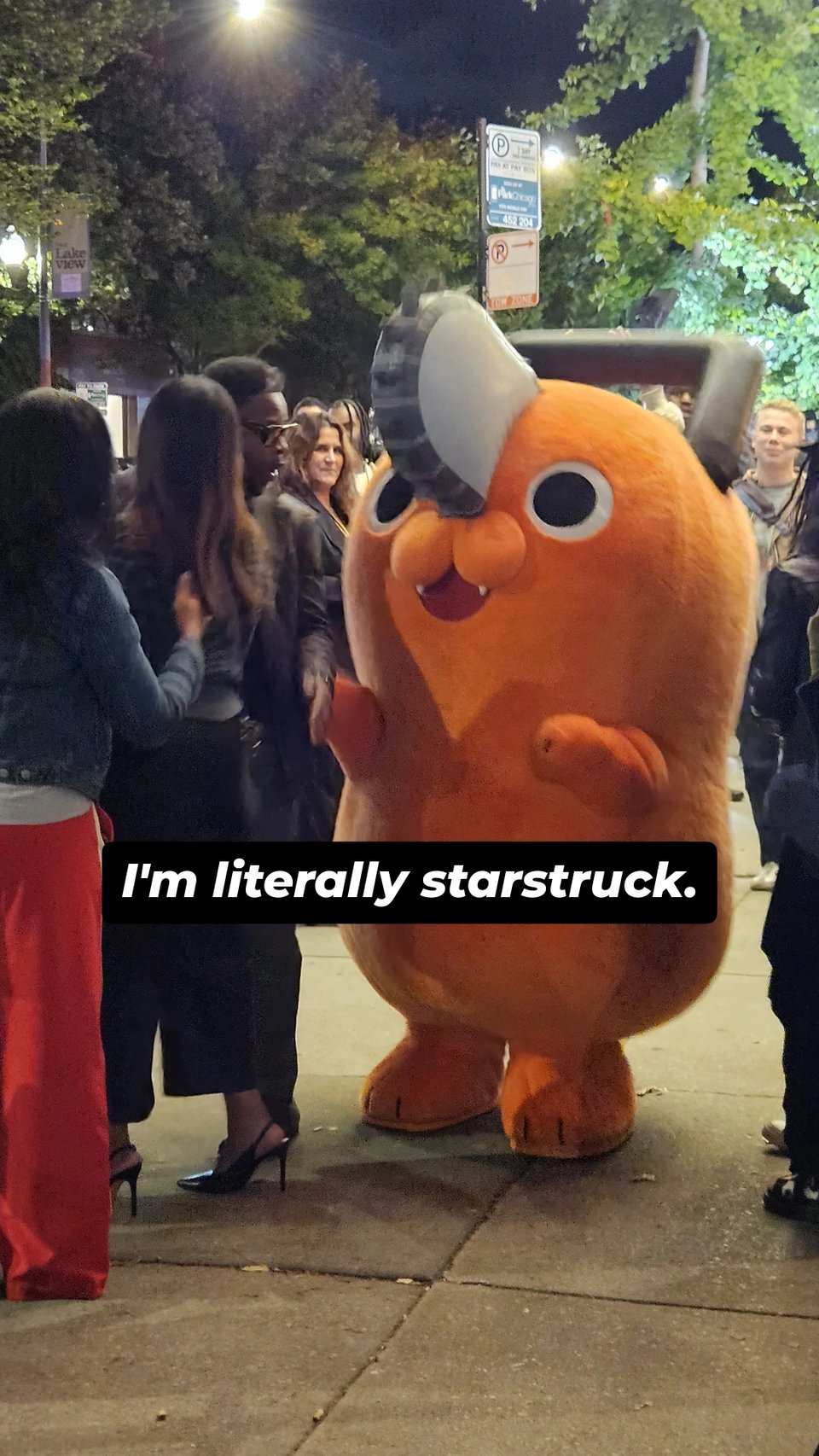 Photo of a large mascot suit of Pochita from Chainsaw Man in a crowd of people. The caption "I'm literally starstruck." across the center of the image.