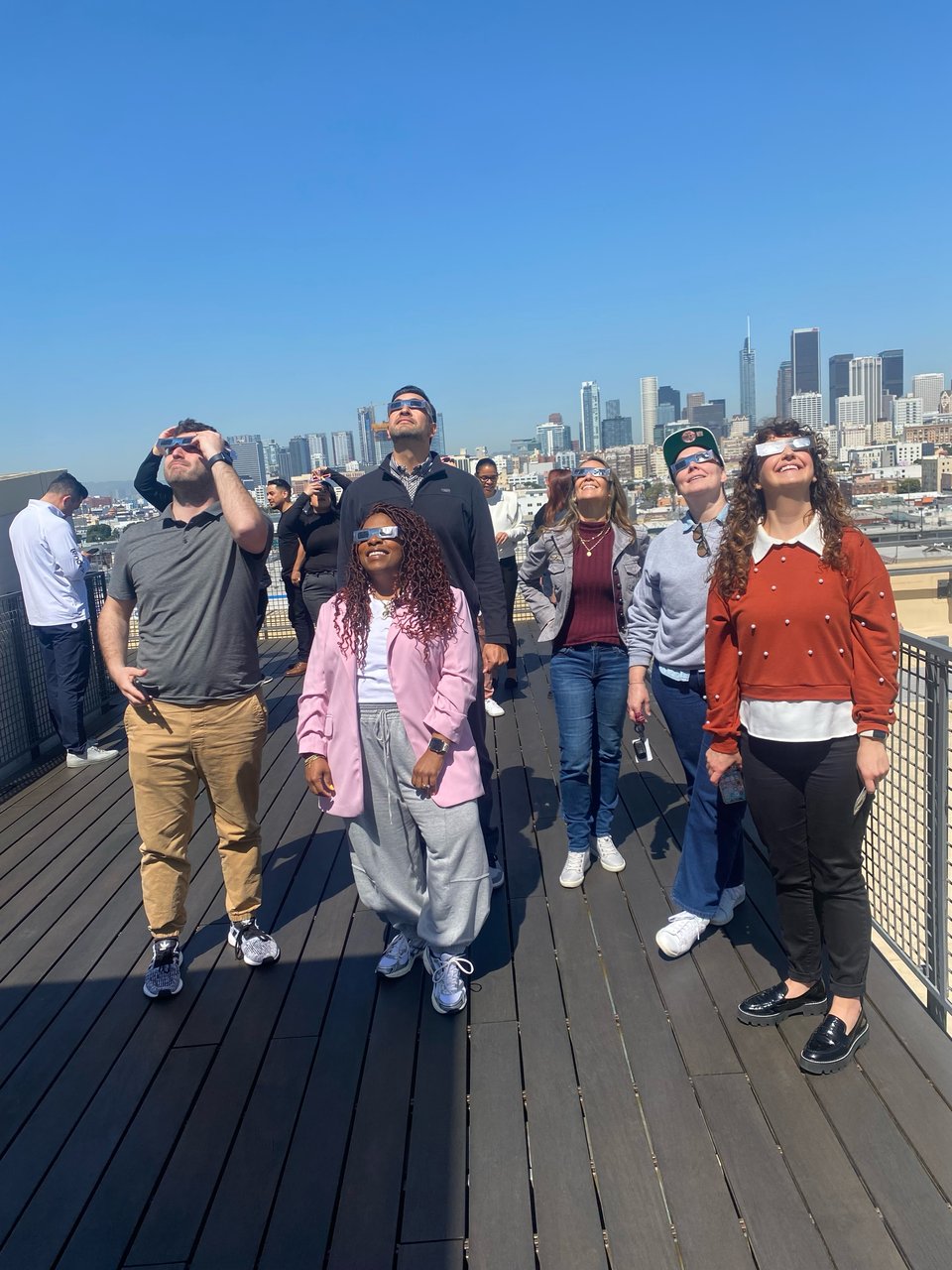 a group of people looking at the sun