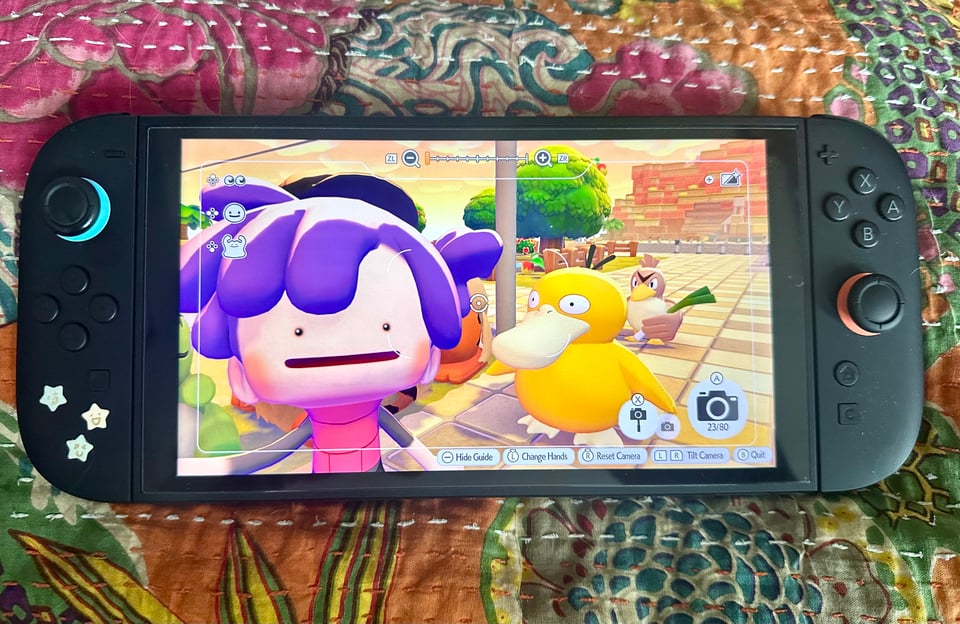 a switch 2 with a screen of my Ditto taking a selfie with Psyduck and Farfetch'd