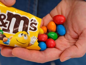 woman-pouring-m-ms-candies-her-hand