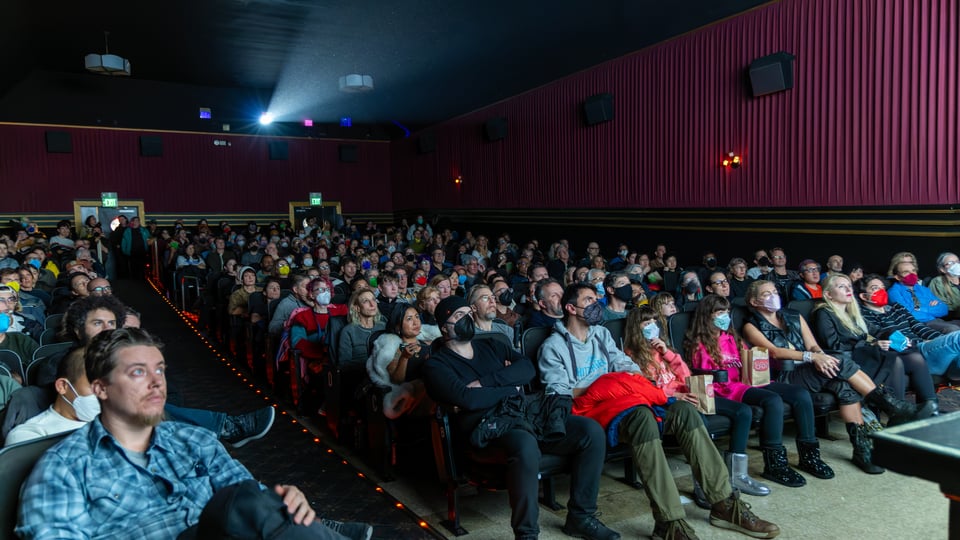 A full theater audience watches Antarctica Unearthed