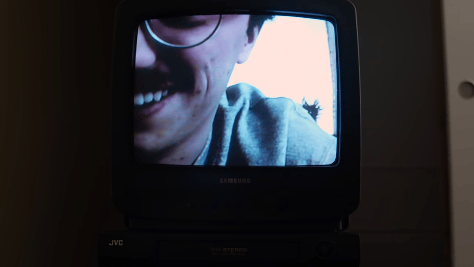 A television showing someone leaning in close to the camera.