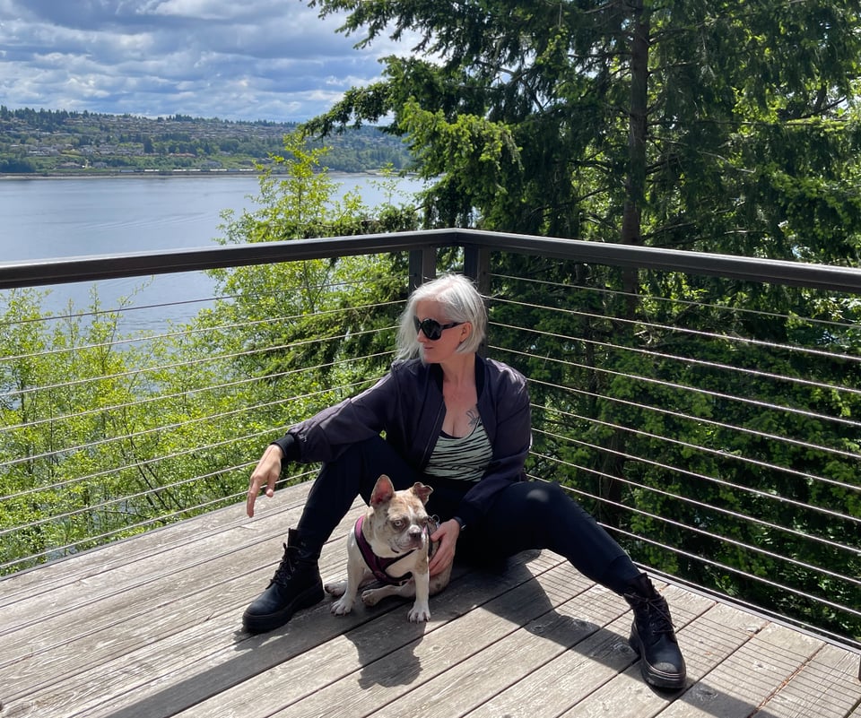 Me as a adult with a French Bulldog sitting on the deck of the Gig Harbor house overlooking the Narrows.