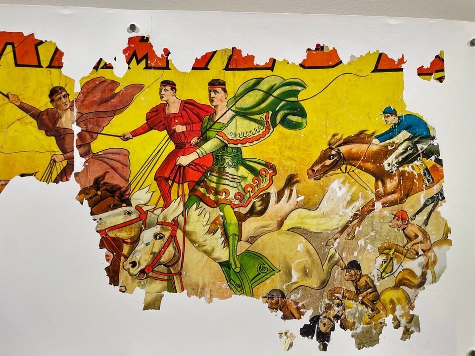 A long strip of a print fragment showing guys in funny Roman costumes standing on galloping horses. Also, monkeys riding ponies.
