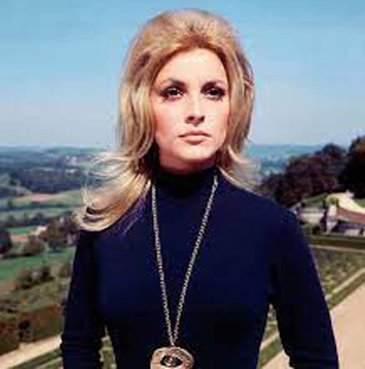 Sharon Tate stands in the castle garden in Eye of the Devil.