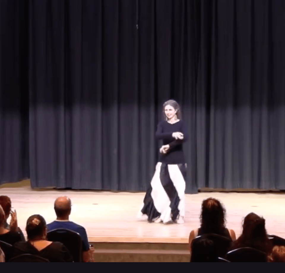 Photo description: A dancer in black and white on a stage