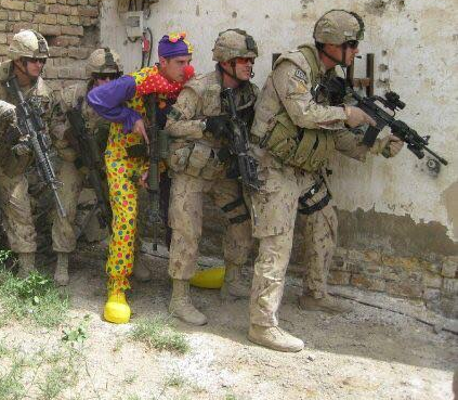 The 'army clown' meme: five soldiers stacked in formation. Four are in proper uniform. One is in a clown costume. Source: imgflip.