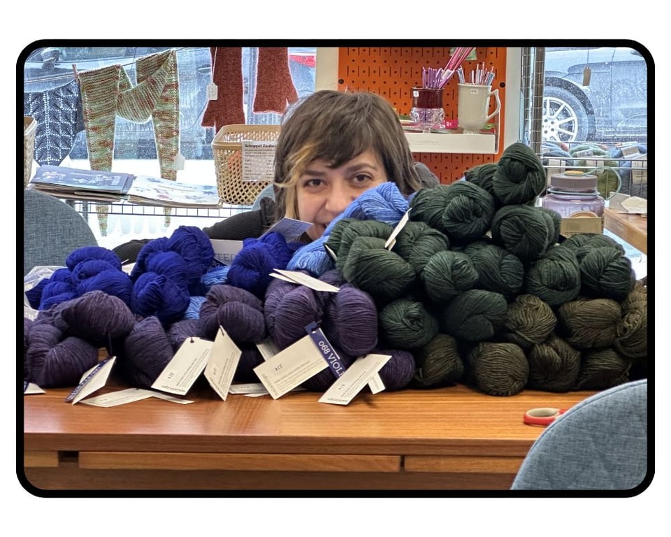 cesca behind a big pile of yarn