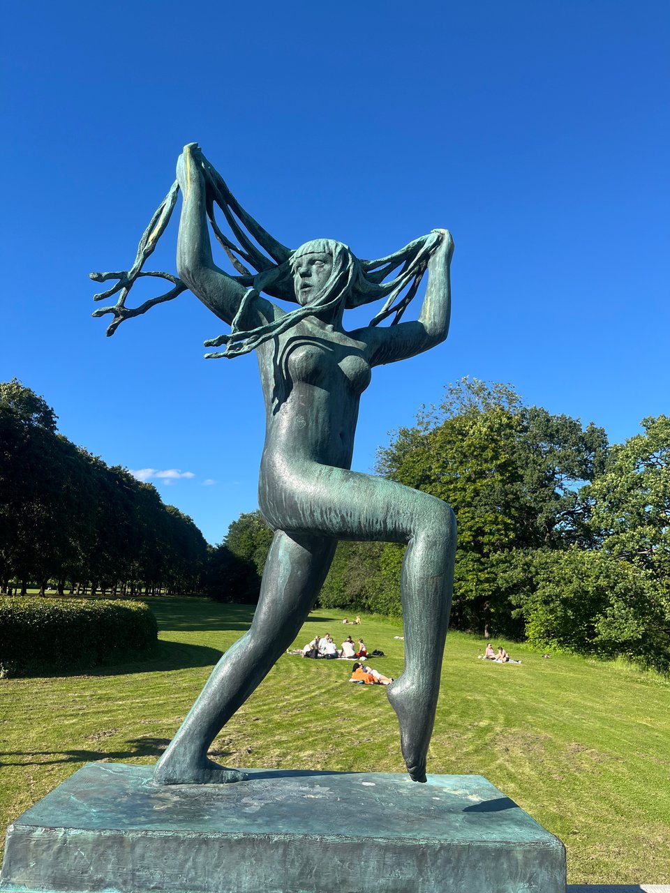 Statue of naked woman with long hair dancing
