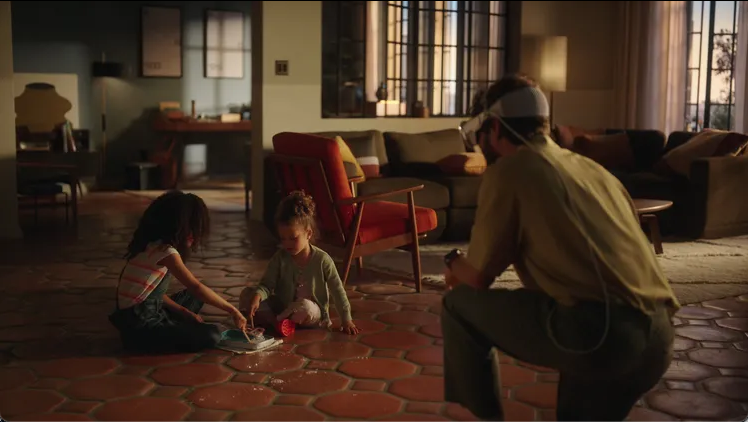 A father wearing a Vision Pro watching his children play
