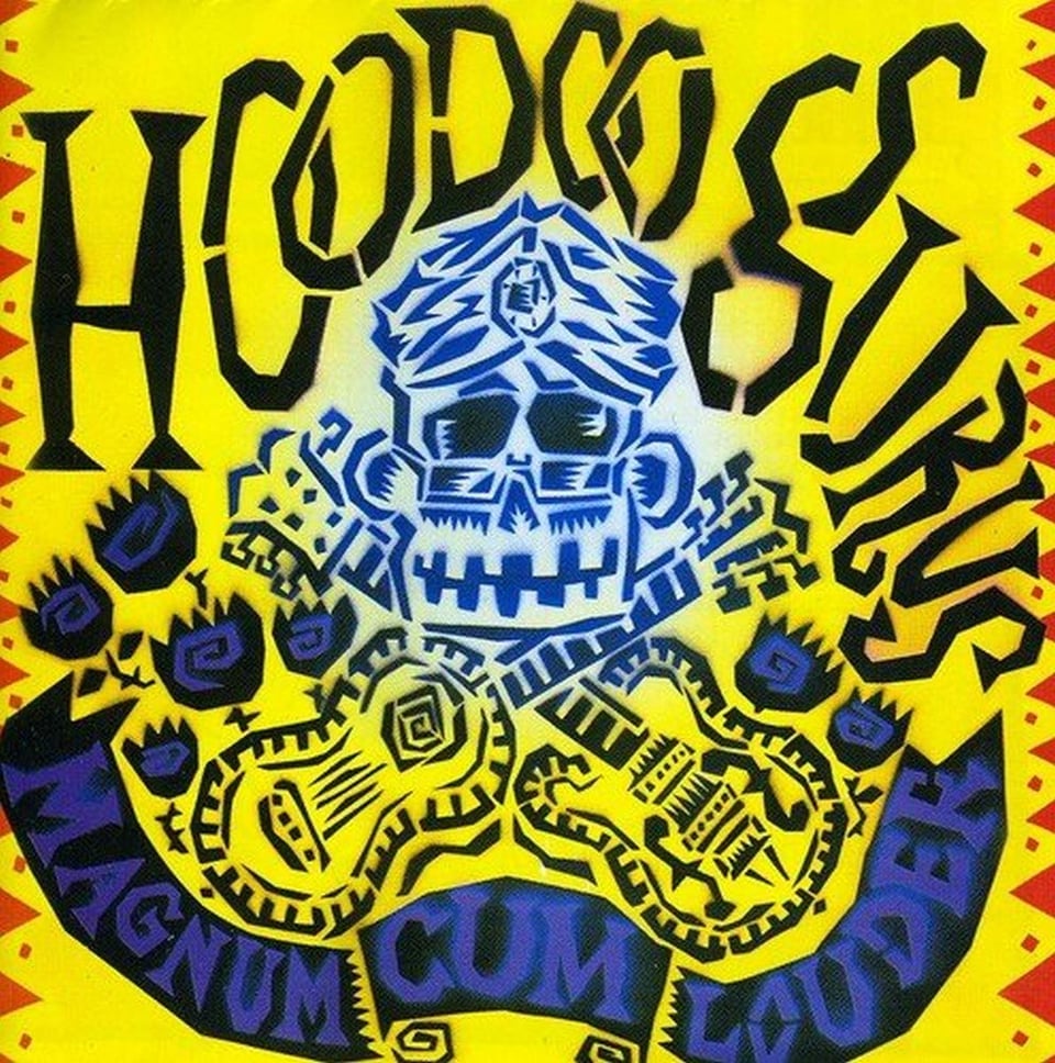 A blue drawing of a smiling monkey-skull-like face, with a jeweled-turban and glasses. Below the face are two crossed guitars, making a kind of "skull and bones" picture. Dotted around the gutiars are what I think are supposed to be black roses. A black banner across the bottom reads "MAGNUM CUM LOUDER." All of this is on a yellow background.