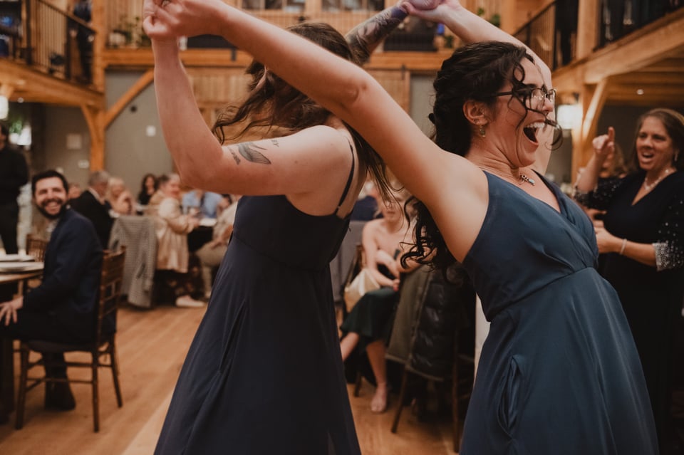 two bridesmaids dancing at a wedding reception