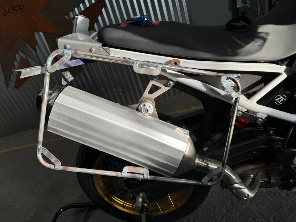 The non-working luggage rack on the right side of the bike.