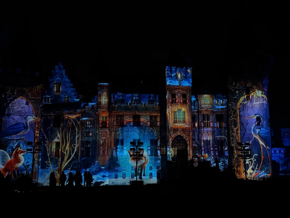 A nightscape of lights over a castle.