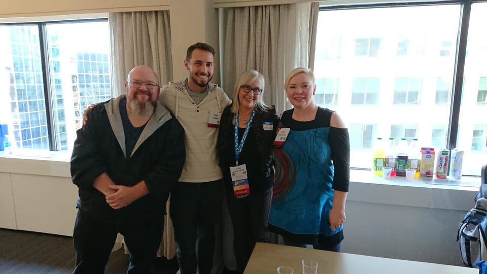 Kevin, Rich, Julie and Kate in the consuite. Kate is wearing a blue and black cold shoulder tunic dress. (I should pull that one out of the depths of the closet -- it was a good dress!)