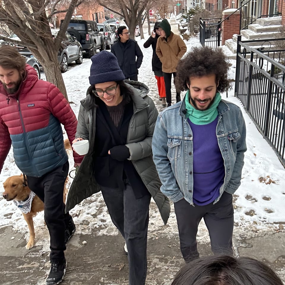 A group of people (plus a dog!) on a walk.