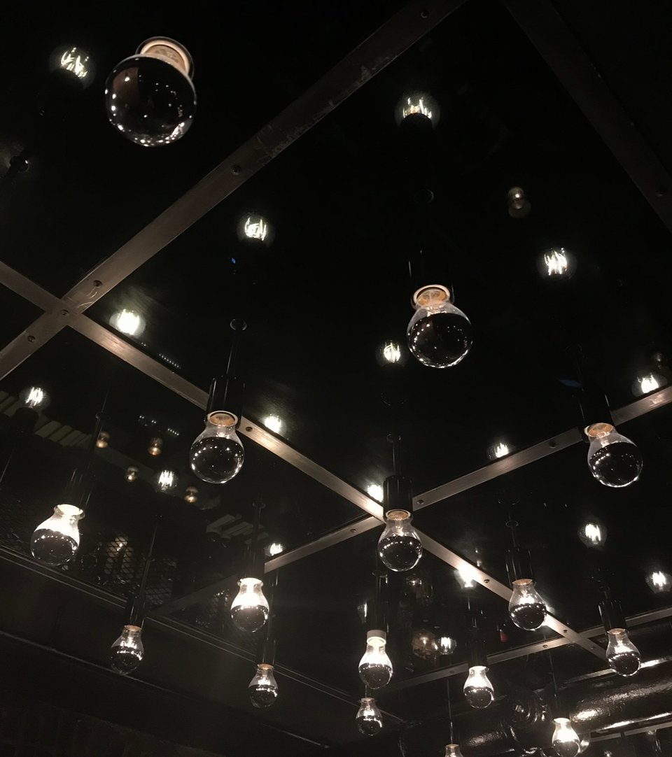 Lit Tesla bulbs hanging from the ceiling of Patent Pending bar, New York City
