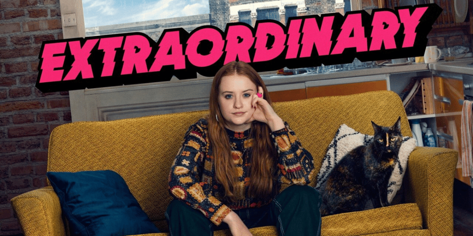 a woman sitting on a couch with a cat