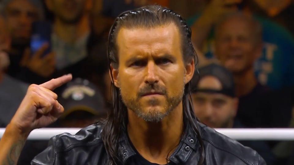Adam Cole doing his patented AEW entrance pose, albeit a bit more orange than usual.