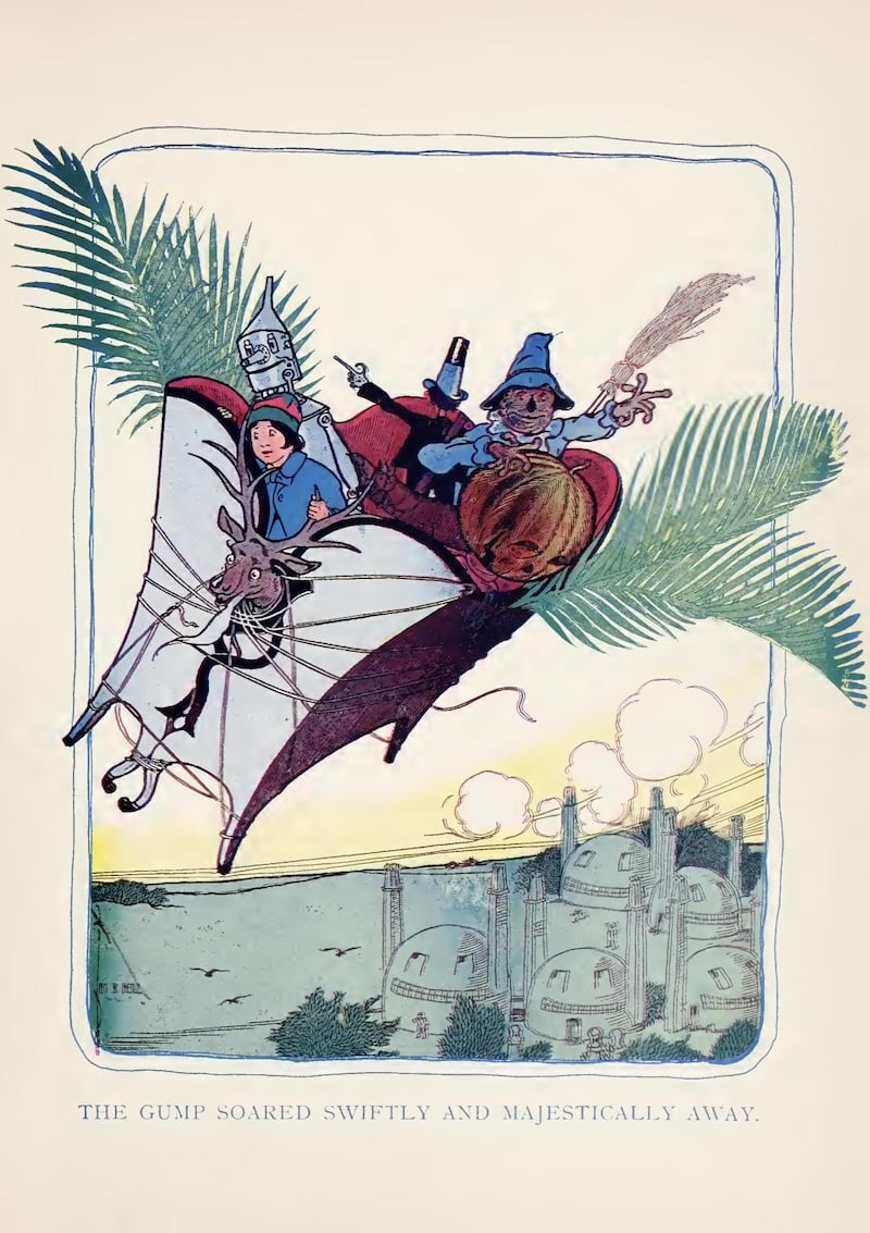 A kind-of huge antelope made of palm fronds and sofas, flying through the air with a bunch of people riding it