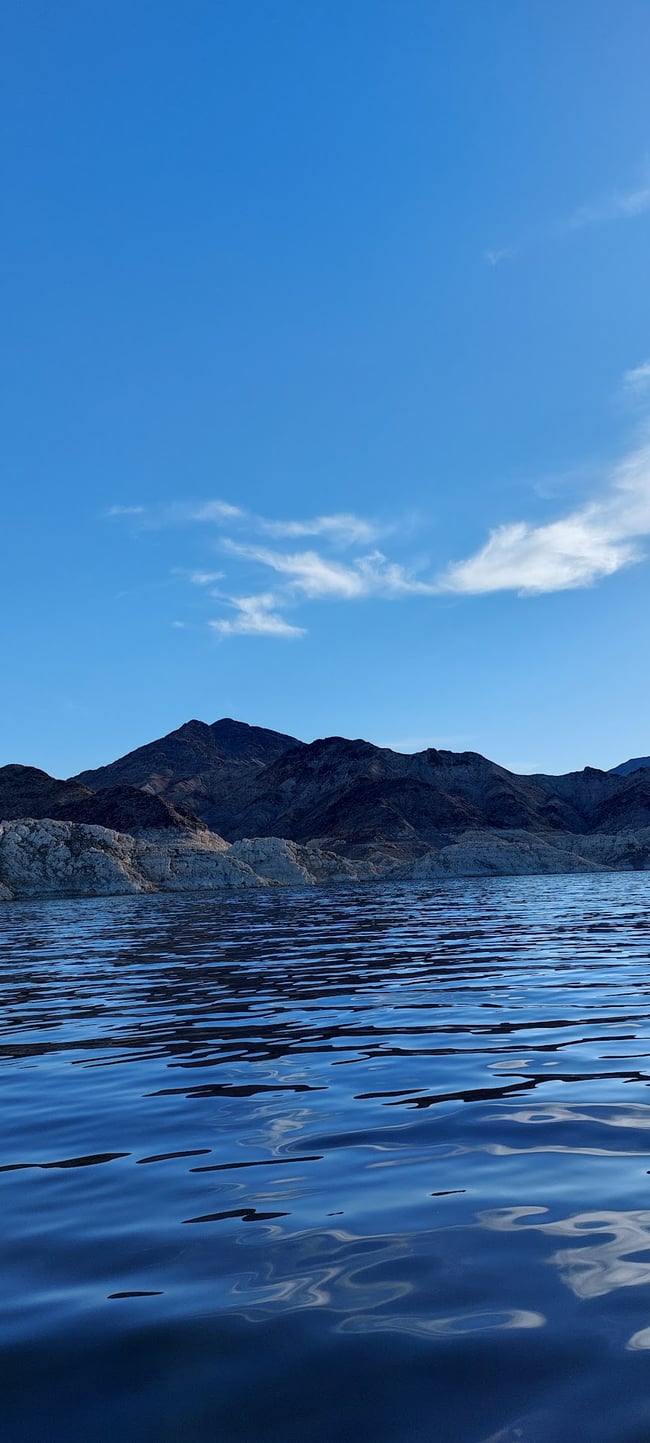 A photo of Lake Mead in Nevada, with a mountain and rocky terrain in the distance.