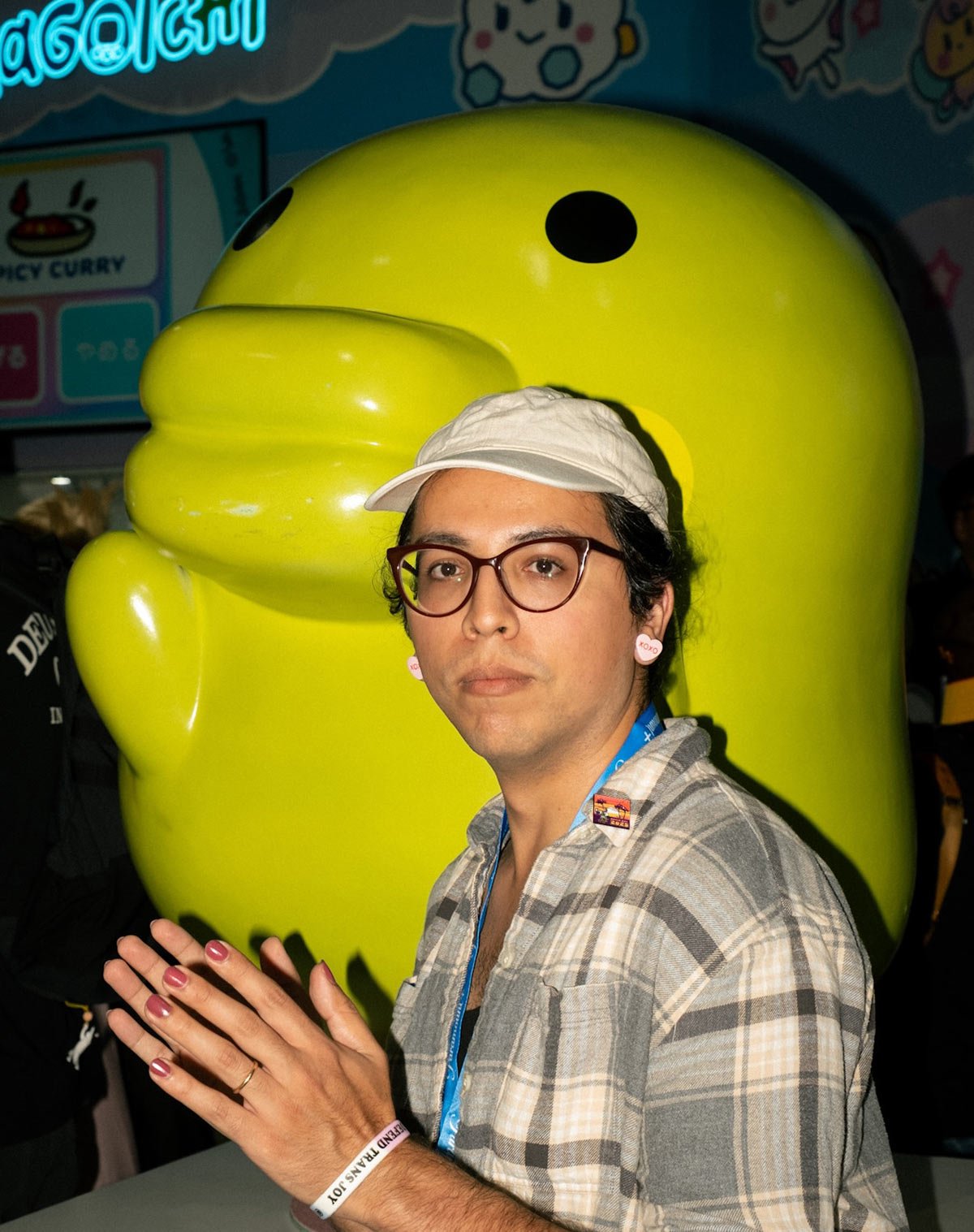 Photo of me in front of a giant lime green Tamagochi.