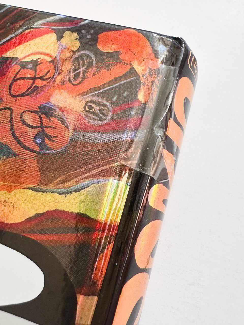 a detail of the spine of Bodyworld that shows tape applied to an inchlong section of the spine.