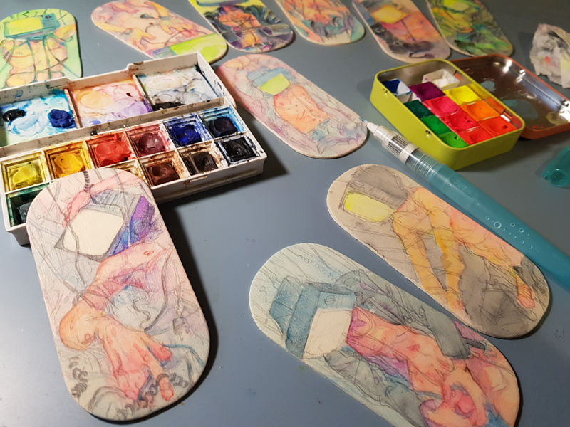 A snapshot of in-progress NSFW TV Head guy paintings on wood.