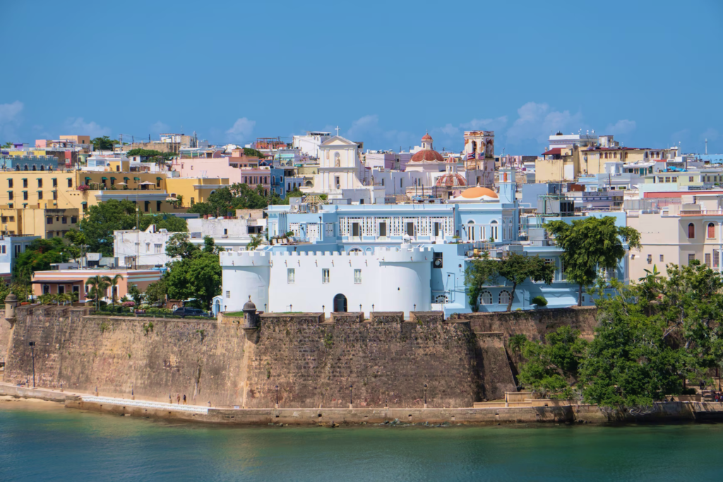 The pastel buildings of Old San Juan above the old city walls on San Juan Bay