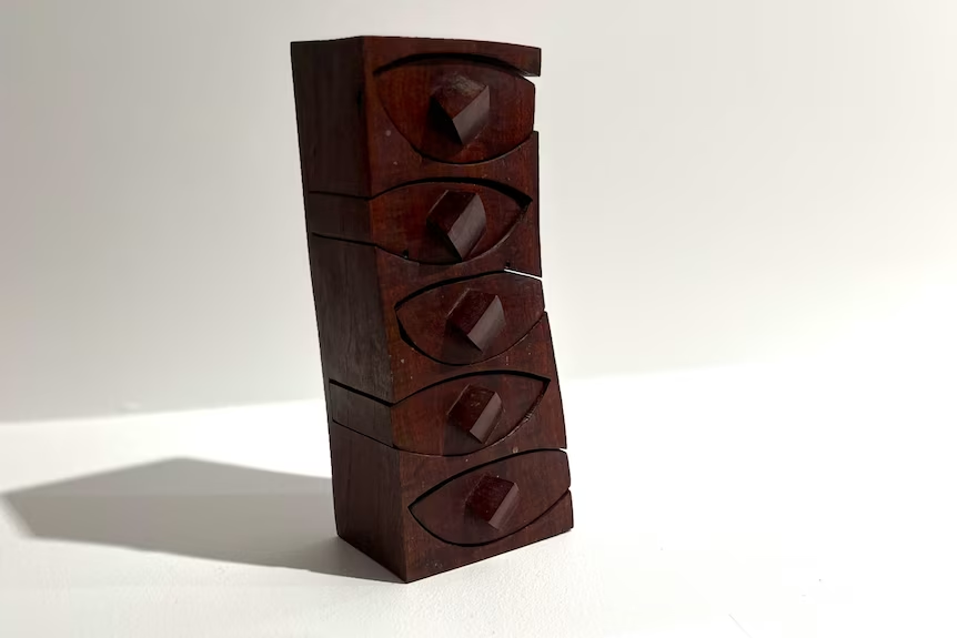 A wooden box with oval-shaped drawers
