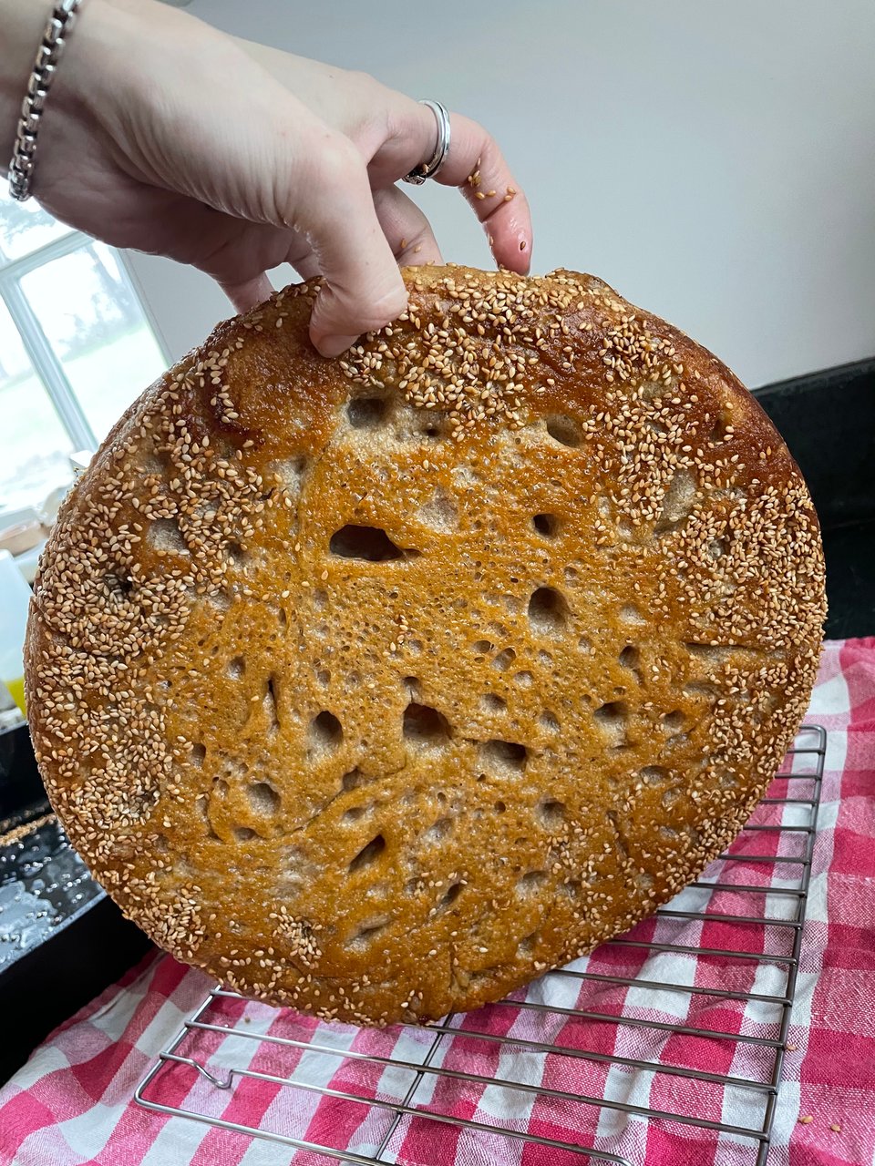 the bottom of focaccia, covered in sesame seeds