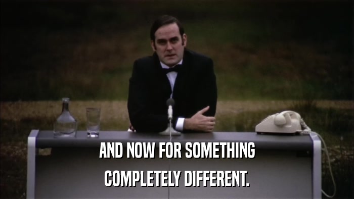a guy in a suit, at a desk, saying, “And now for something completely different”