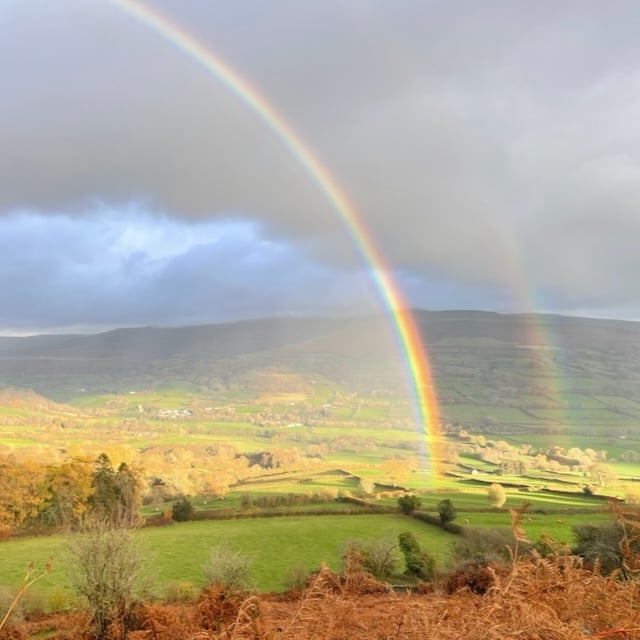 Distant view of Cwmdu with rainbows.