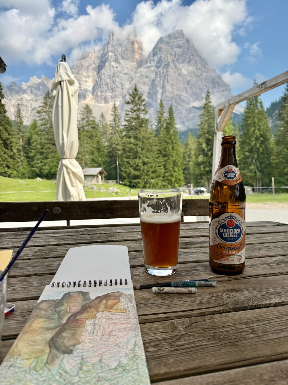 painting and beer at a table in front of rocks