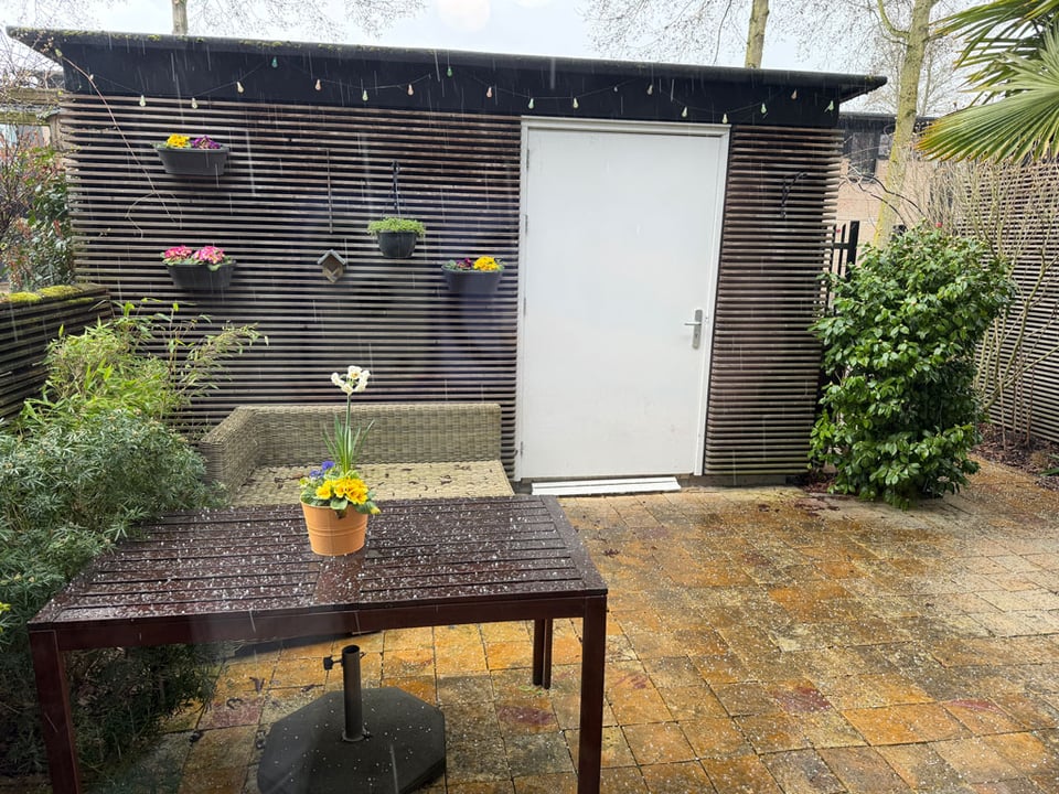 Hail rains down in a garden patio.