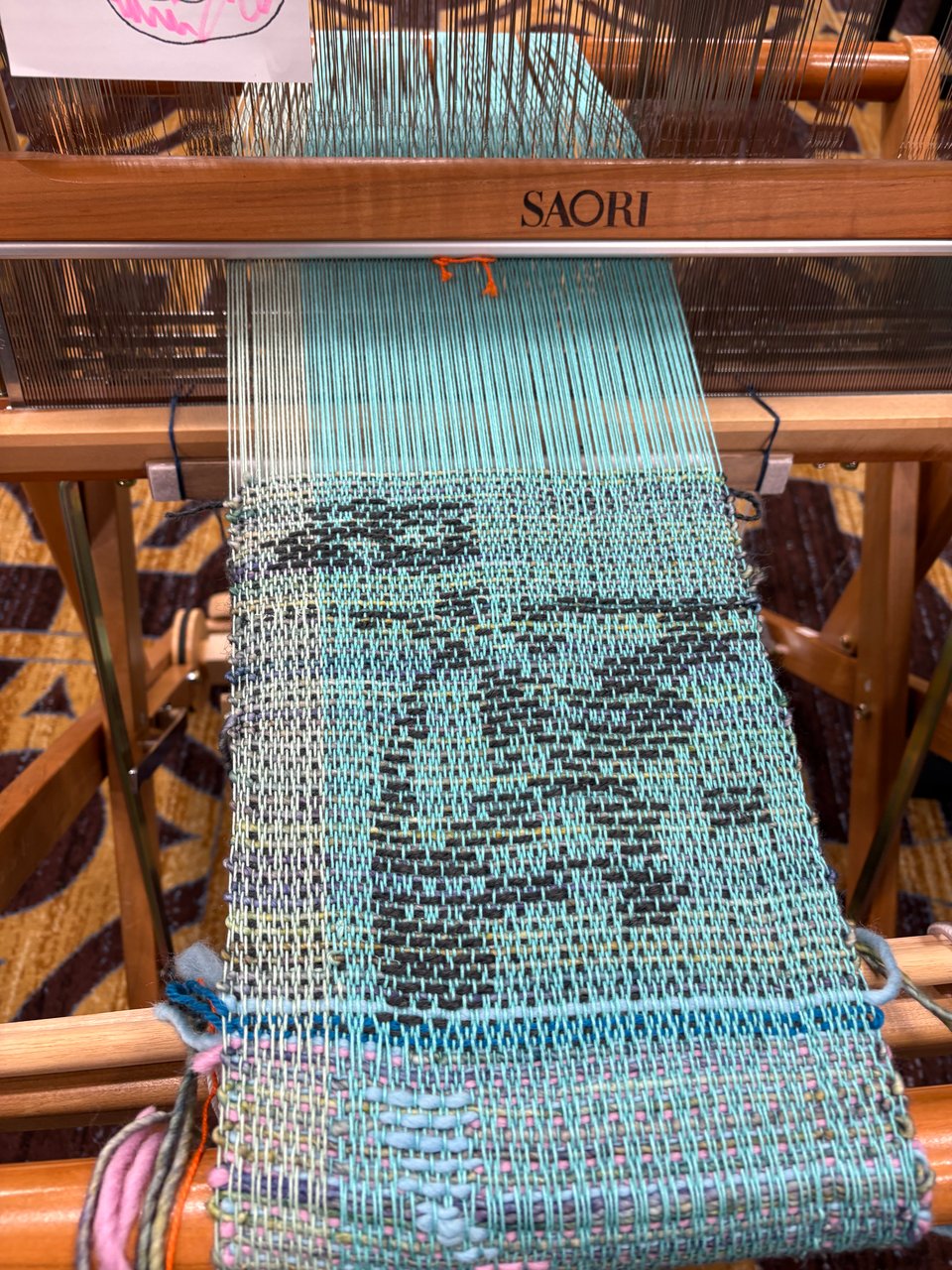 example lopsided "moth" motif in a split-shed weaving practice piece on a four-shaft loom