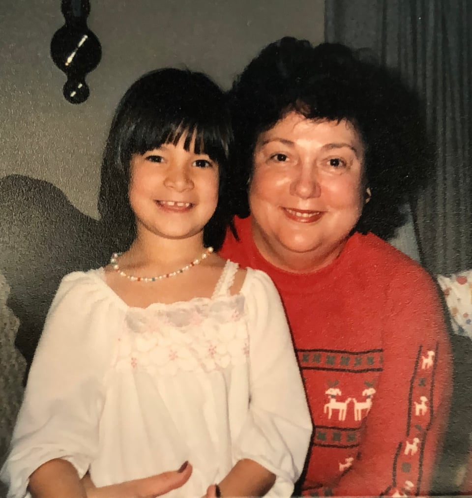 a young five year old Chicana being hugged by her white grandma