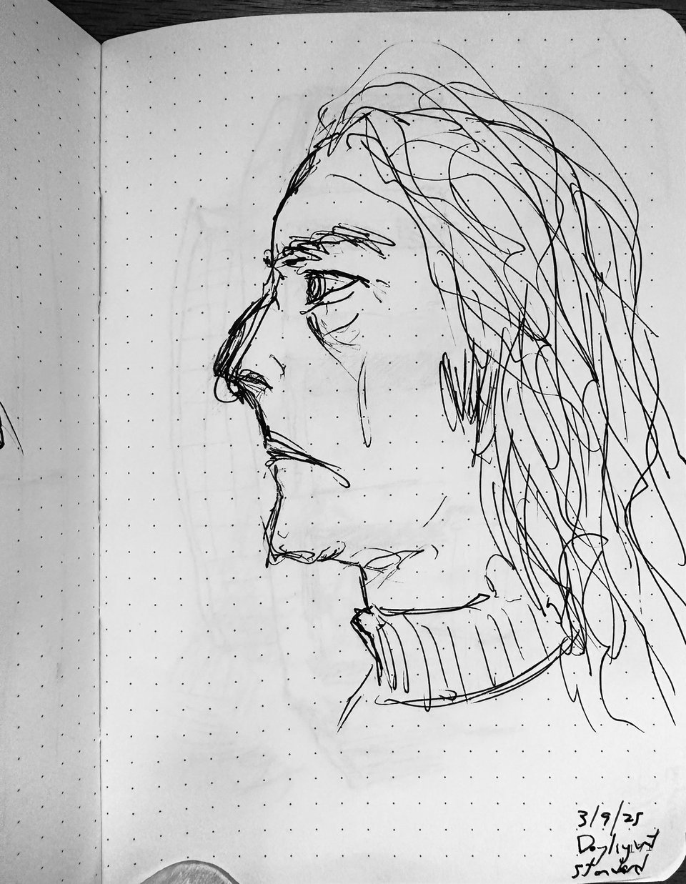 photo of quick ink-sketch pf a man in profile, wearing a turtleneck. He has long curly hair, apparently, and several overlapping noses