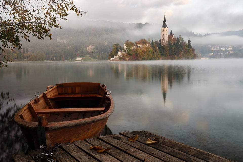 photo of boat with castle in background