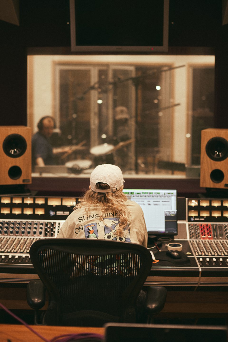a girl in front of a mixing desk