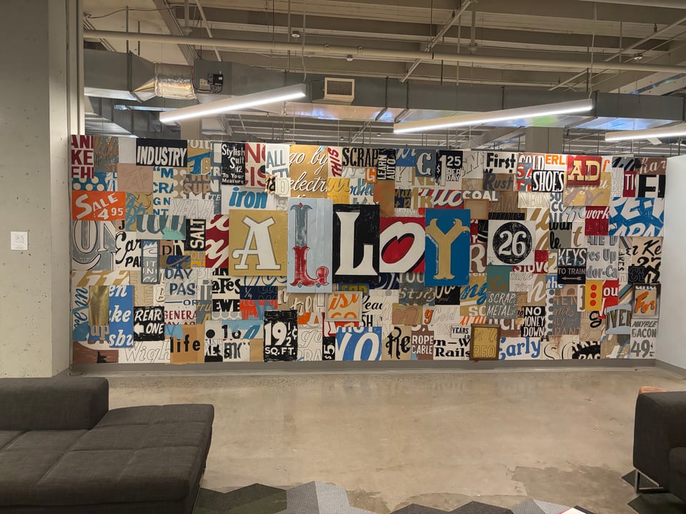A collage-like mural on the wall of a coworking space in Pittsburgh