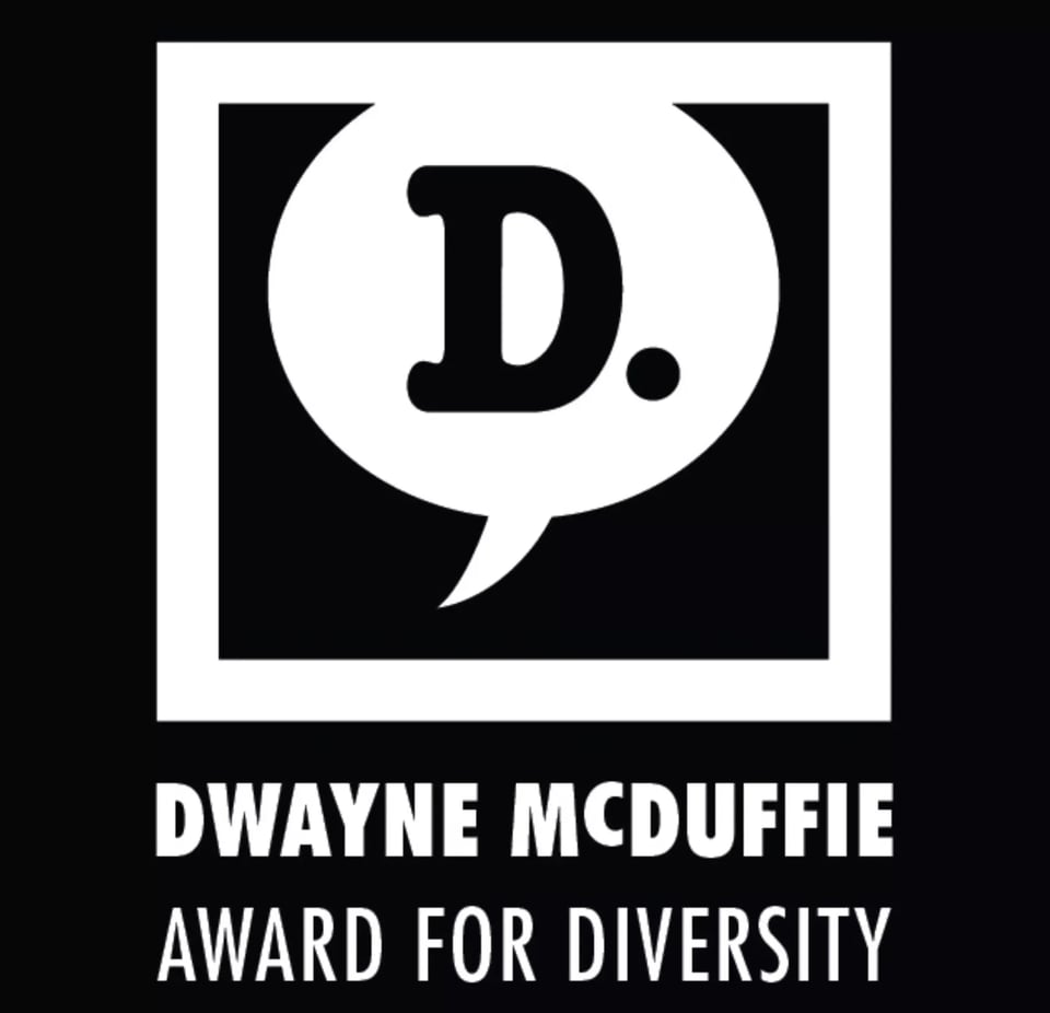 The Dwayne McDuffie Award for Diversity logo. Against a black background, a square with a white border houses a white word balloon, with a black "D." inside it. Below the square, in white, is the award's name.