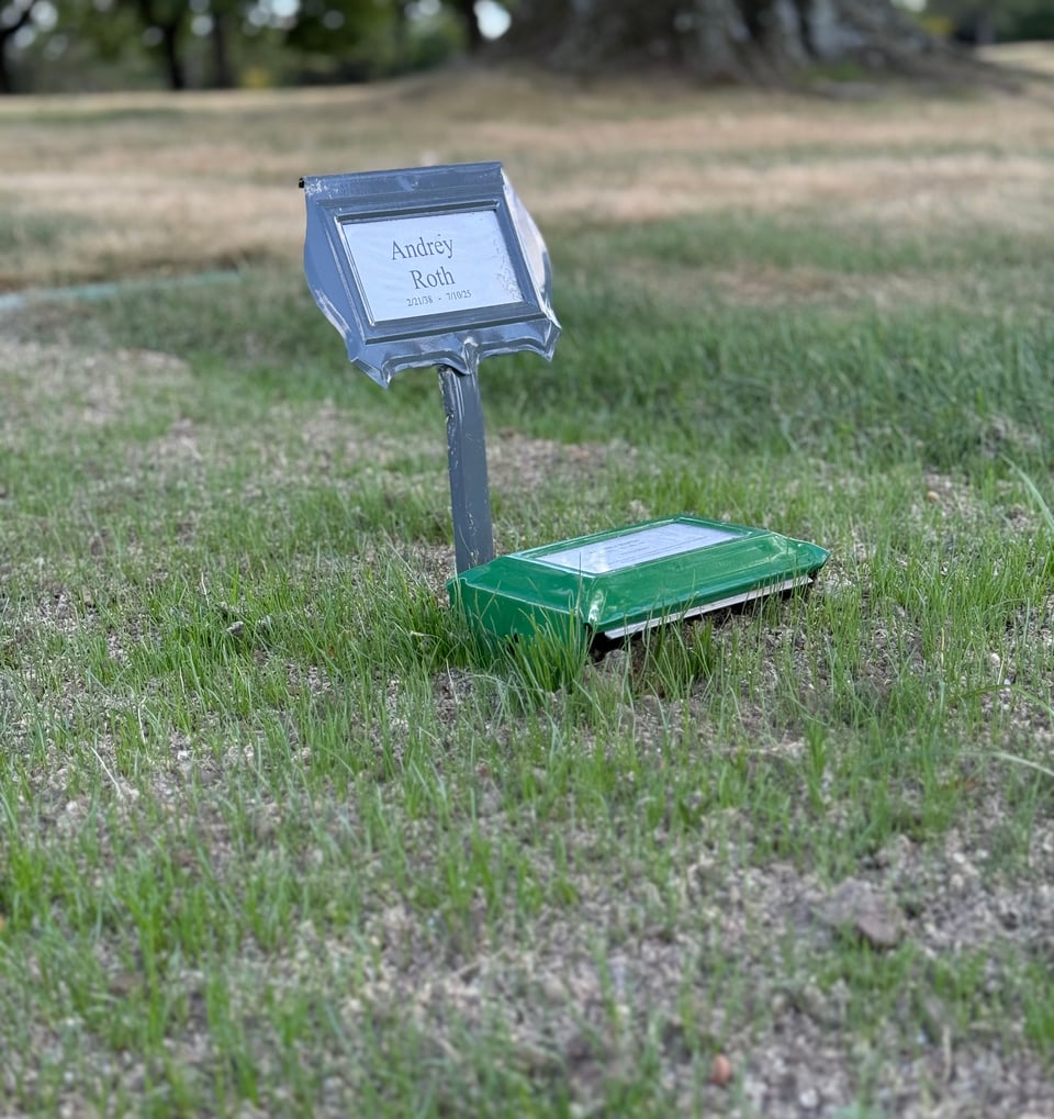 photo of grave with temporary marker for Andrey Roth, with grass beginning to grow around it